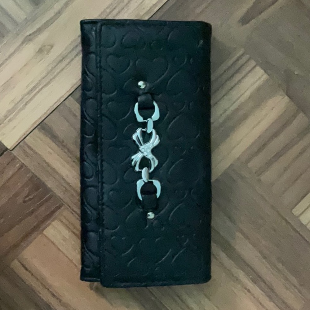 Y2K style wallet. Very cute and minimalist. Black heart patterns on the outside.